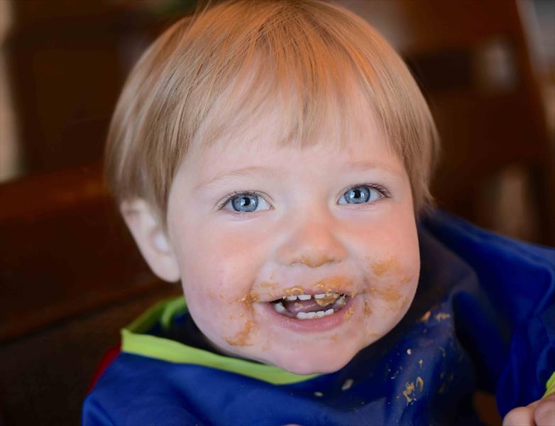 Baby eating peanut sales butter